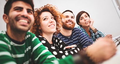 row-of-people-smiling-at-table Recruiting Happy Qualitative Research Participants