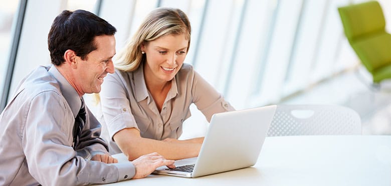 man-and-woman-working-together-on-laptop