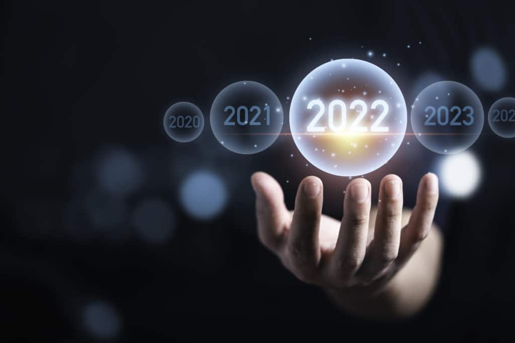 Man hand holding virtual 2022 year in bubble