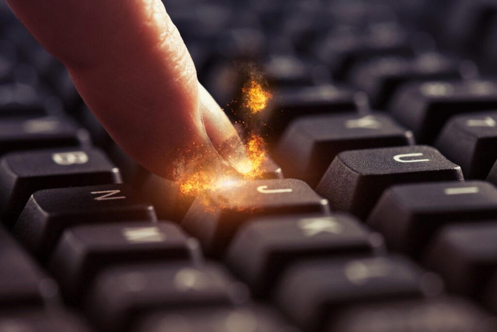 woman's fingertip on a keyboard Ignites in flame